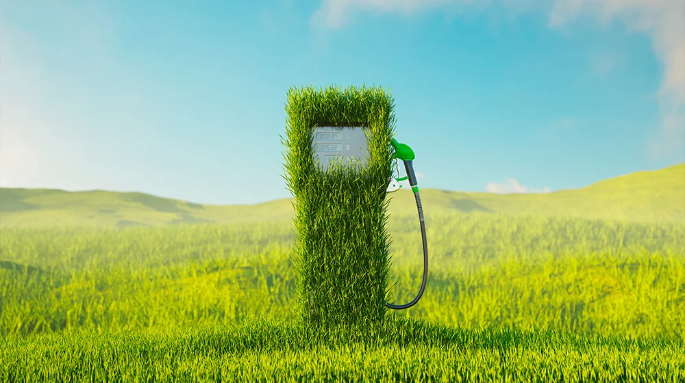 Grass sculpture shaped like a fuel pump in an open field.